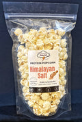 Protein popcorn with Himalayan salt flavor packaging on a dark background